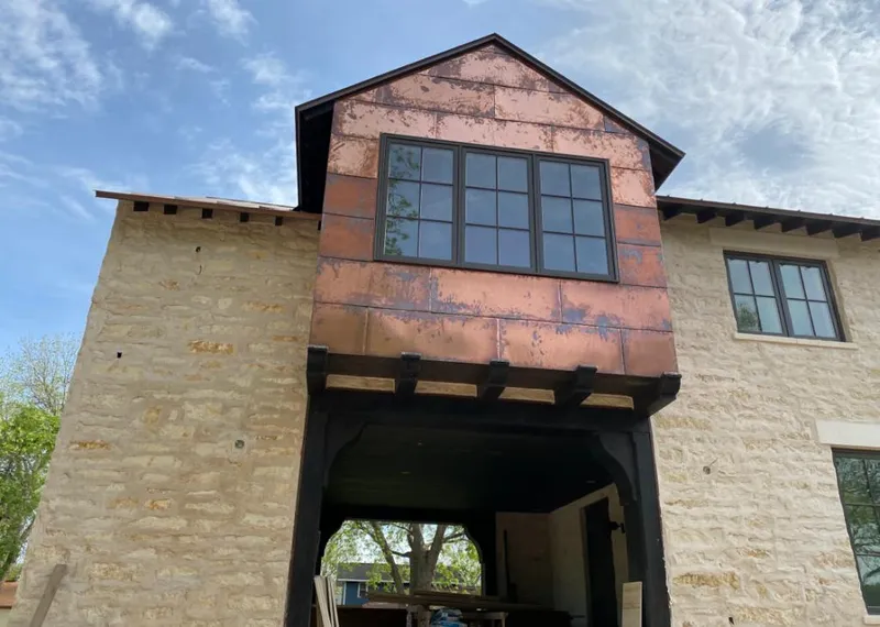 Copper metal panel facade on a stone building for Skylight Installation in Lake Magdalene